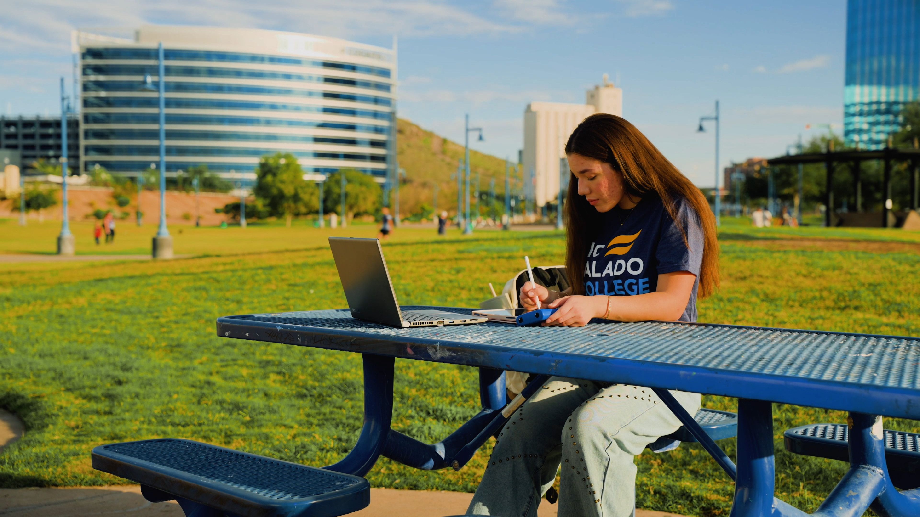 Student at picnic table with computer